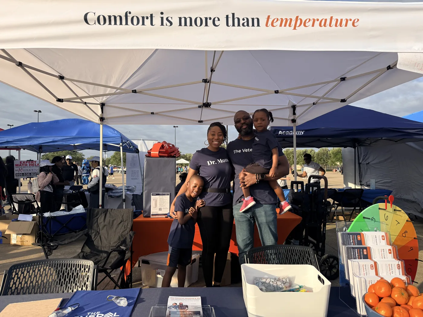 The Sampson family at The General Heating & Air's booth at a community fun run in Cypress