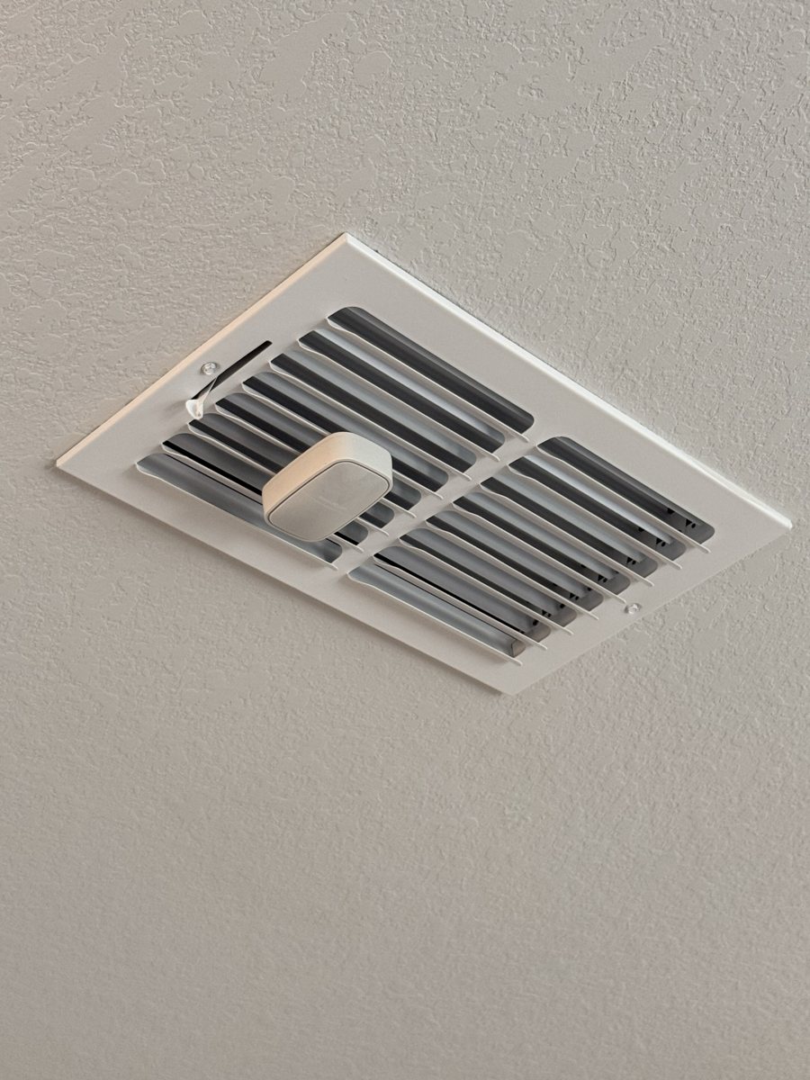 A comfort sensor installed on a supply vent in a Cypress home