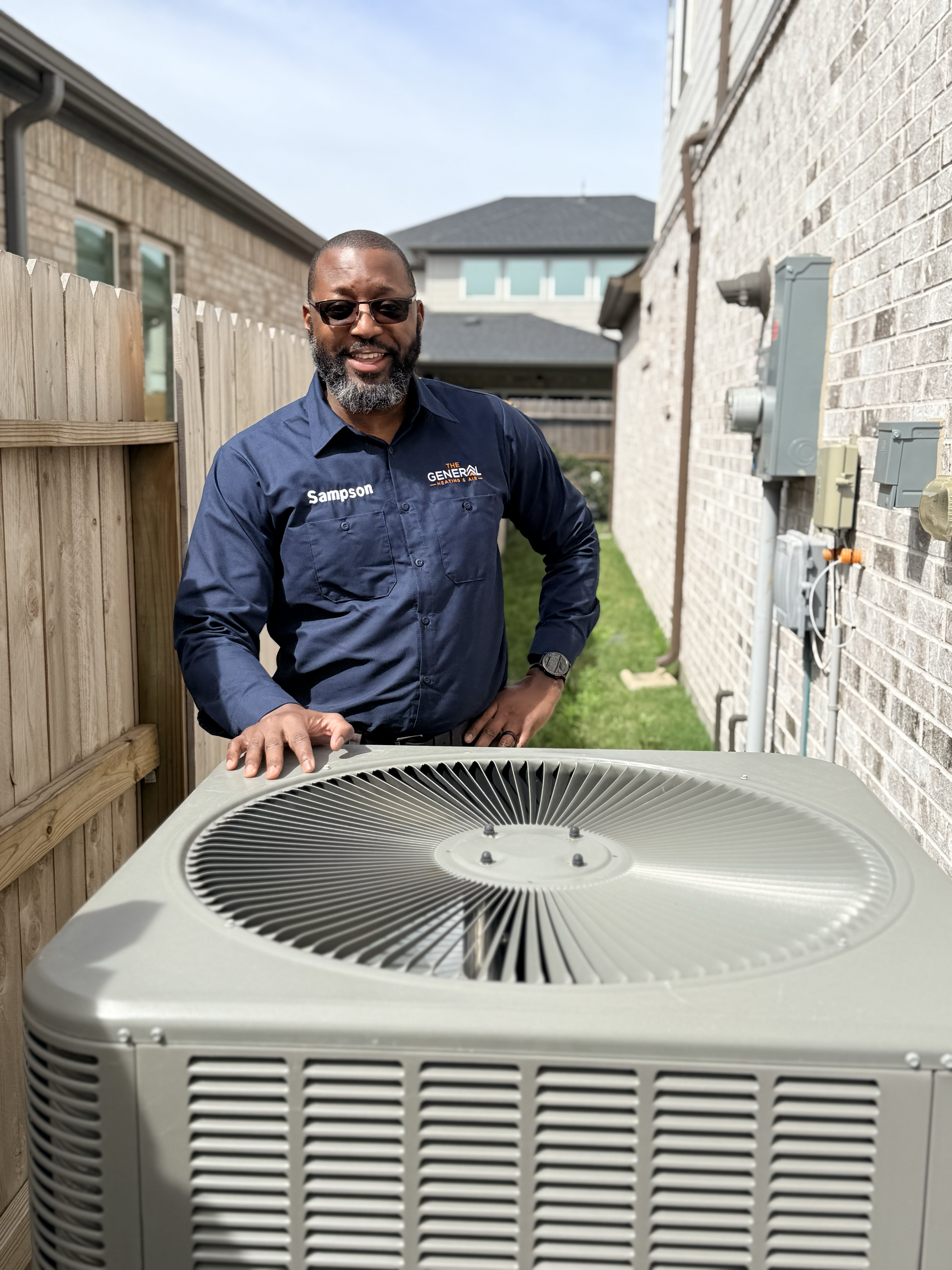 An outdoor AC condenser unit beside a home